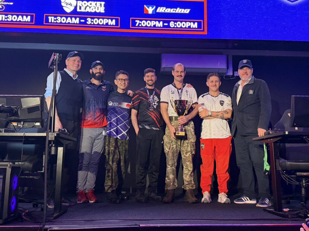 VelociDrone UK winner AS1 Kieran Oldham at IDEG26 with others on stage