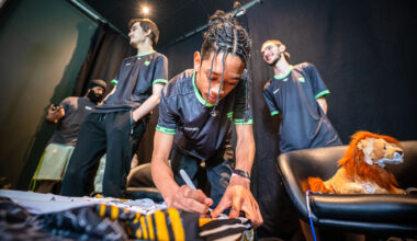 Students signing the main Student Champs Jersey for 2023