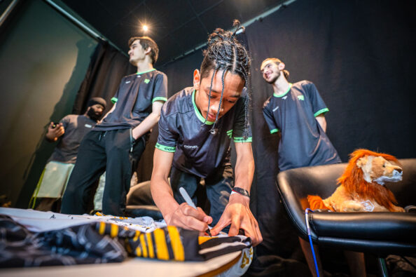 Students signing the main Student Champs Jersey for 2023