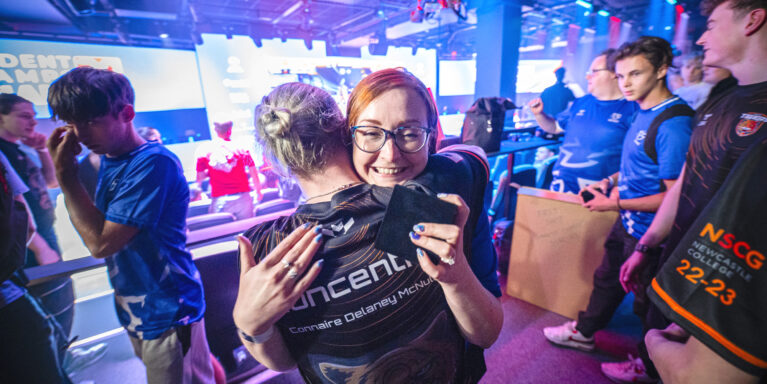 Gil Hamilton of SGS Esports embracing a player at the British Esports Student Champs finals in 2023